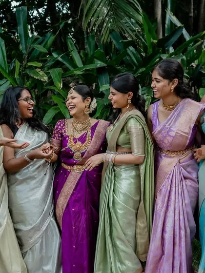 The fun and games of wedding rituals. This moment of laughter during a post-wedding game shows the playful spirit and strong bond between the couple and their families.