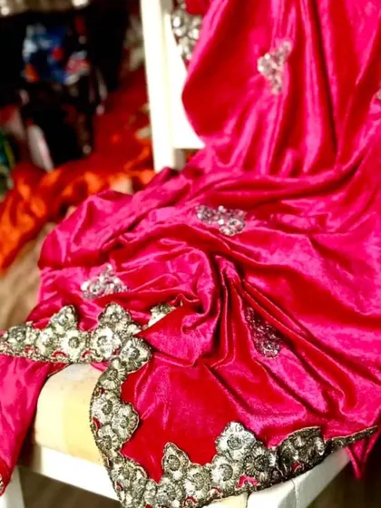 A luxurious fuchsia velvet saree with hand-embroidered borders and bootas. The lycra velvet drapes beautifully for a slimming effect, making it a rich and glamorous must-have for the winter wedding season.