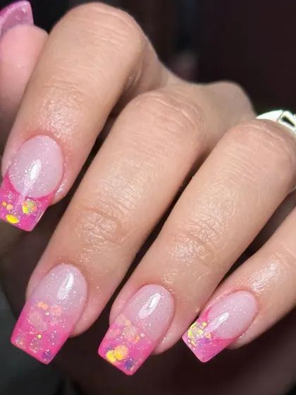 A closer look at an inbuilt acrylic French ombre. Notice how the glitter is seamlessly blended and sealed within the nail. This technique ensures the design is smooth and won't chip or fade.