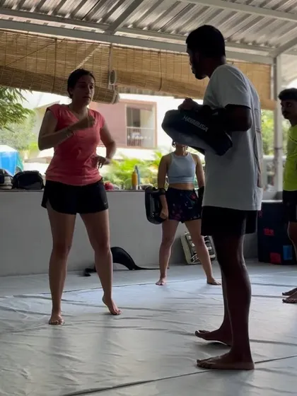 A female member getting some personalized instruction on her form.