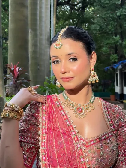 A classic portrait pose, showcasing the entire makeup and jewelry look.