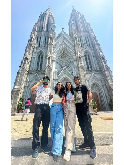 A low-angle shot of our group at St. Philomena's Cathedral, capturing the grand scale of the neo-gothic architecture.