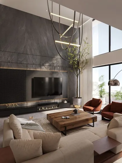 A different view of the double-height living room, showcasing the dramatic stone-clad TV wall, modern fireplace, and the custom chandelier that fills the vertical space.