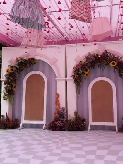 The performance stage is ready, with floral-adorned arches and a playful ceiling creating a fun and festive atmosphere for family and friends to celebrate.