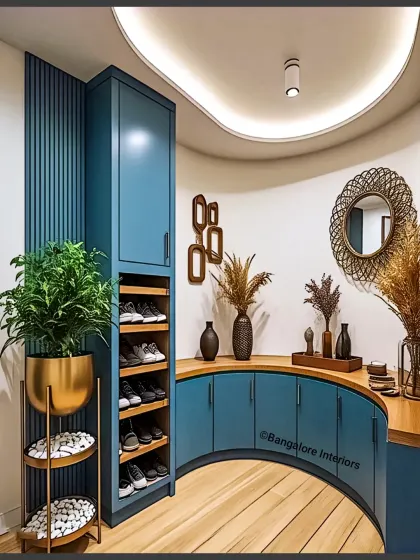 A unique, curved entryway unit in a beautiful blue finish. This custom piece includes a curved cabinet and an open shoe rack, designed to fit perfectly into an unconventional space.
