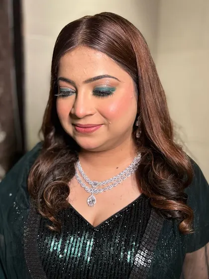 A close-up of the emerald green smokey eye, a bold and beautiful choice for a sangeet night.