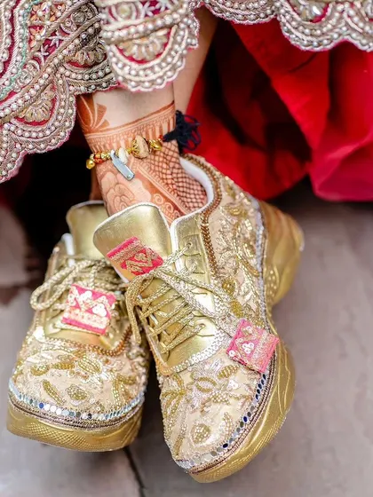 A detailed shot of the bride's custom wedding sneakers.