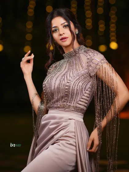 This shot captures the full elegance of the outfit and the moment. The combination of the detailed top and the flowing skirt is perfect for a glamorous event photography session.