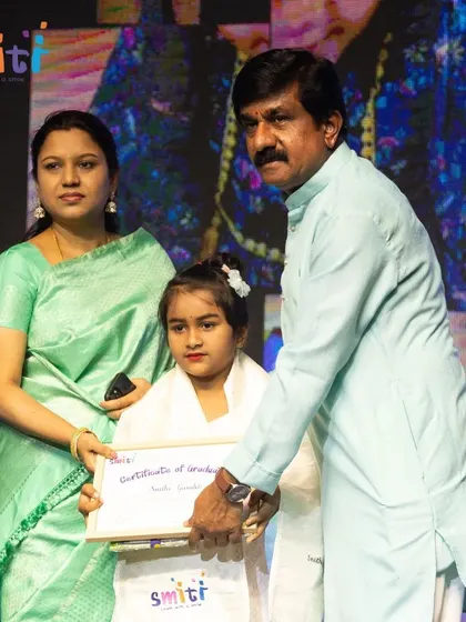 A graduate receives her certificate, a symbol of her hard work and learning.