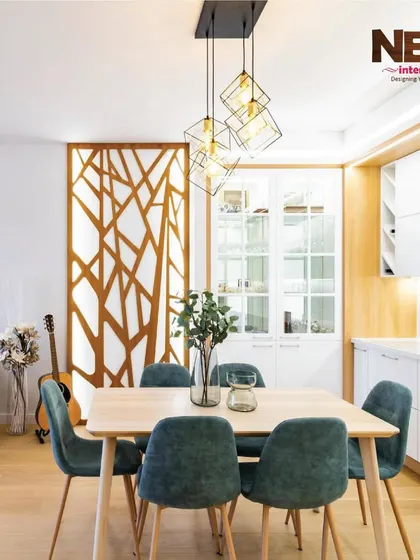 A well-designed dining area with a statement light fixture and a wooden partition. This is part of a package I offer for affordable 2BHK interior solutions.