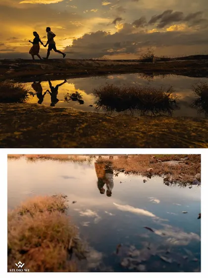 A stunning reflection shot of a couple running at sunset. The water on the ground acts as a perfect mirror, creating a symmetrical and artistic image.