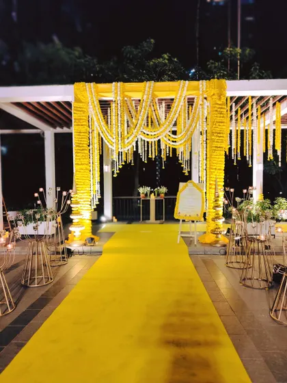 The entrance to the Sai Sandhya was designed as a pathway of peace, with a bright yellow carpet and a pergola draped in strings of yellow and white flowers.