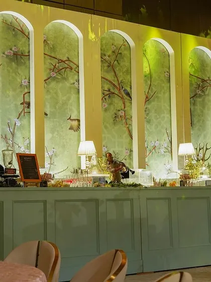 The bar area, set against a beautiful chinoiserie mural. The elegant design ensures that even functional areas are a feast for the eyes.