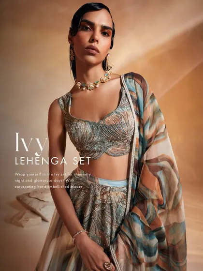 A closer look at the Ivy Lehenga Set, where coruscating hand-embellishments create a dazzling texture on the blouse. This modern lehenga is perfect for shimmery nights and glamorous days, blending intricate motifs with an elegant silhouette.