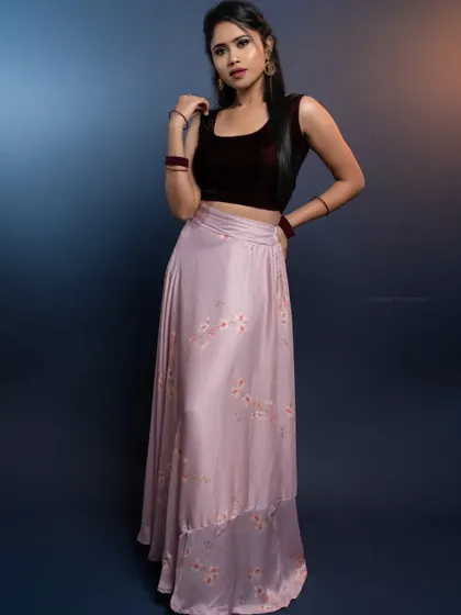 A full-length shot of the same look against a moody blue background.