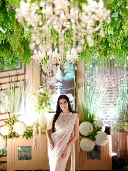 Posing under a stunning chandelier, this shot highlights the luxurious feel of the event and the outfit.