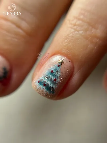 A detailed look at a hand-painted Christmas tree, complete with tiny ornaments and a star on top.