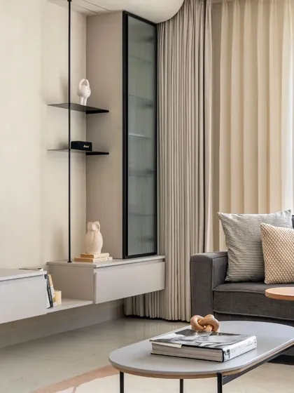 This light and airy TV unit combines metal ledges and lacquered glass for a sense of openness. The mix of grey and textured paint enhances the sleek, modern feel.