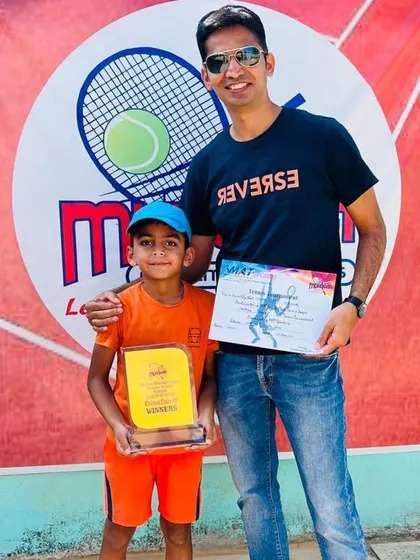 Avyaan with his coach after winning the Under 8 title, a fantastic start to his tennis journey.