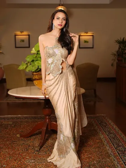 The full-length view of the golden saree-gown, showcasing its modern and chic silhouette.