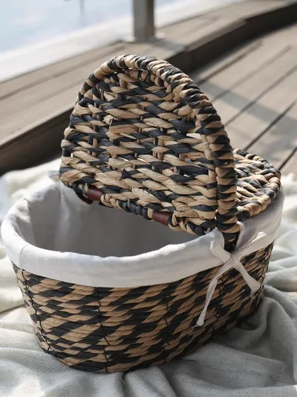 This woven basket with a black and natural pattern and a convenient lid is a chic storage solution. It’s perfect for hiding away clutter while adding a touch of bohemian elegance.
