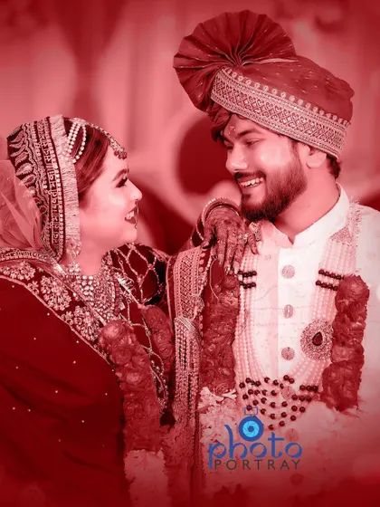 A candid and joyful moment between the bride and groom, edited with a warm red tint for a romantic feel.