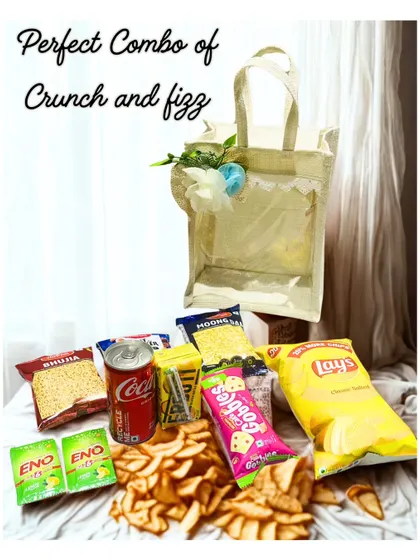 The perfect combo of crunch and fizz. This image shows all the contents of the Crunchy Hamper, including a variety of chips, snacks, and drinks.