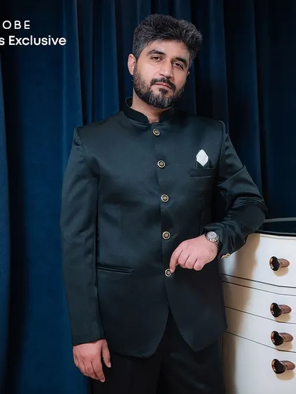 A closer look at the classic green Jodhpuri suit with a mandarin collar and a white pocket square. A timeless choice for any formal occasion.