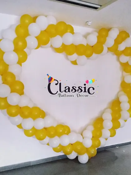 A large heart-shaped balloon frame in yellow and white, creating a lovely photo opportunity.