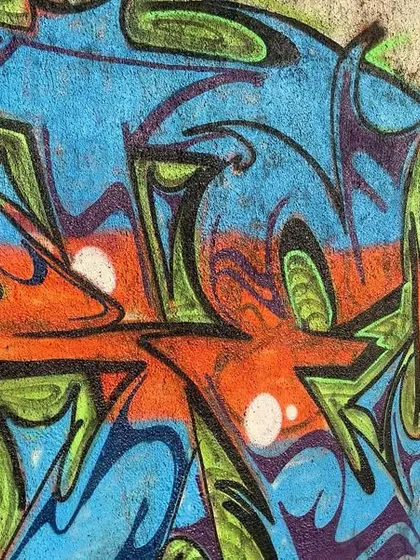 A close-up of the freestyle jam piece, showing the blend of different artists' styles and the raw energy of a collaborative wall.