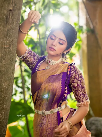 A dreamy, sun-kissed shot of Megha Shetty. The light catches the beautiful texture of the silk saree and the detailed embroidery on her blouse.