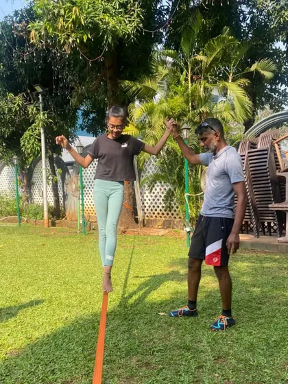 Taking training outdoors. Our players practice on a slackline to improve their balance, core strength, and focus, essential skills for maintaining stability during intense rallies.