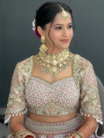 A close-up of Shrriya's wedding makeup. The soft pink eyeshadow and flawless skin create a look that feels both traditional and contemporary, perfectly matching her Gazal Gupta couture.