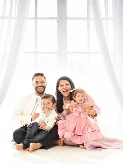 A fun and candid portrait of a family of four. The natural light and genuine laughter make this a truly special image.