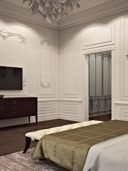 A serene bedroom with intricate white wall mouldings and dark wood flooring, creating a high-contrast, classic look.