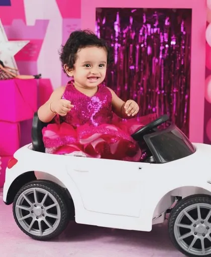 Ready to ride in style. The miniature white convertible is the perfect accessory for a Barbie-themed birthday or milestone shoot.