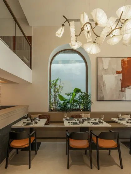 A view from the mezzanine level shows the relationship between the two floors, connected by the open space and the consistent, calming design language.