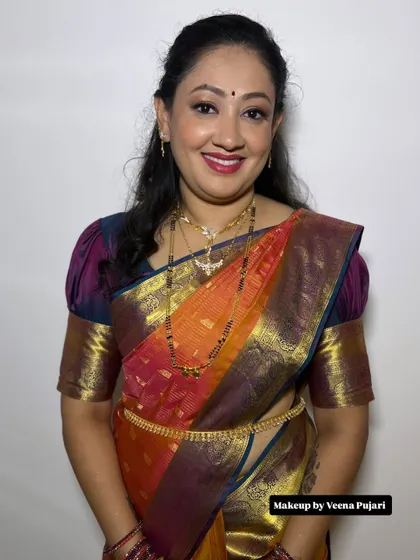 A warm and happy smile from this lovely client. Her multi-colored silk saree is perfect for a festive occasion.