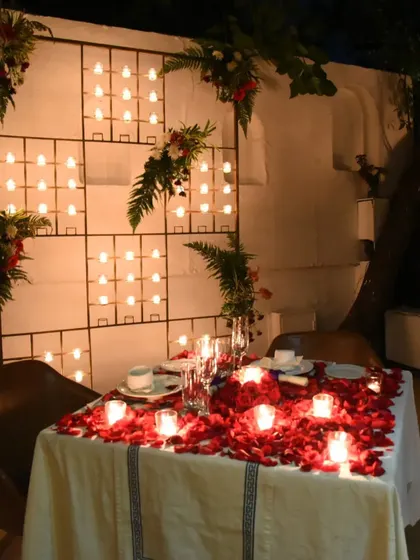 A closer look at the candle wall and rose petal table decoration, a popular choice for romantic evenings.