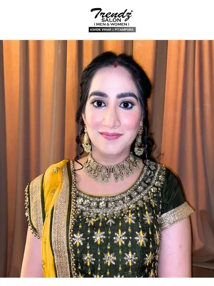 The final festive look. The client looks radiant and ready for her Karwa Chauth celebrations, with makeup that is both traditional and glamorous.