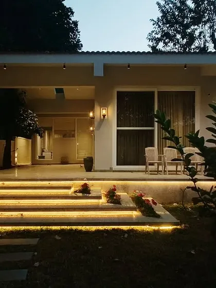 The warm, linear lighting under the steps at Amberle provides a beautiful contrast to the cool tones of the twilight sky, creating a picture-perfect moment.