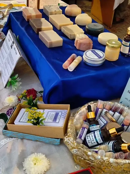 A colorful display of my products at The Golden Spiral fair. The basket is filled with lip balms and hair oils, ready for customers to explore.