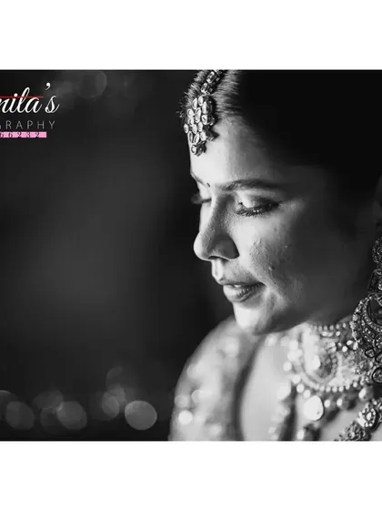 A timeless black and white portrait. This close-up shot captures the bride's elegance and the quiet moments of reflection on her wedding day.