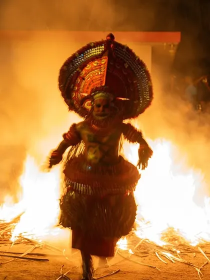 A sequence documenting the Kandanar Kelan Theyyam's fearless dance through fire. These images show the performer's complete surrender to the flames, a testament to the ritual's power.