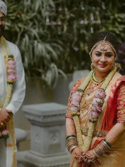 A classic portrait of the bride and groom, dressed in traditional attire and ready for their wedding ceremony.
