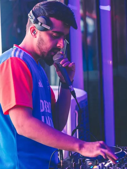 A close-up of me on the mic, wearing the Indian team jersey. I love to bring a sense of unity and shared spirit to my events.