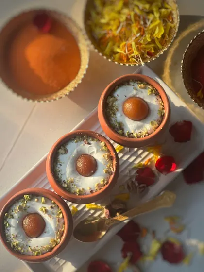 A fusion dessert that's always a hit. My Gulab Jamun Cheesecake is served in traditional clay kullads, combining a creamy cheesecake base with a soft gulab jamun on top.