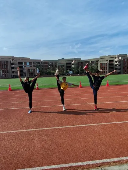 Our gymnasts striking a pose on the track at the ISSO Nationals. They bring their flexibility, strength, and spirit to every aspect of the competition.