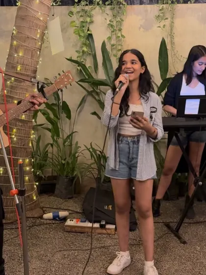 A young singer captivating the audience with her voice during our live music night. The energy during these events is always incredible.