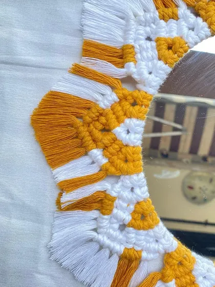 Another detail shot of the boho mirror, highlighting the texture of the macrame cord and the neatly combed fringe.